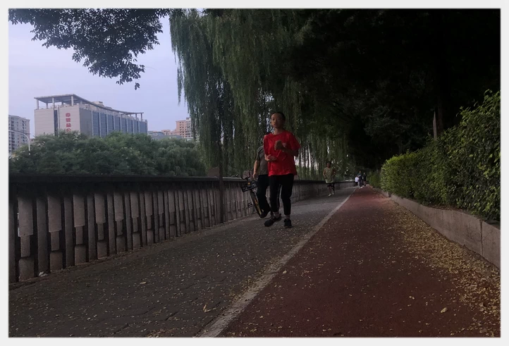 People Running along the city moat trail. 