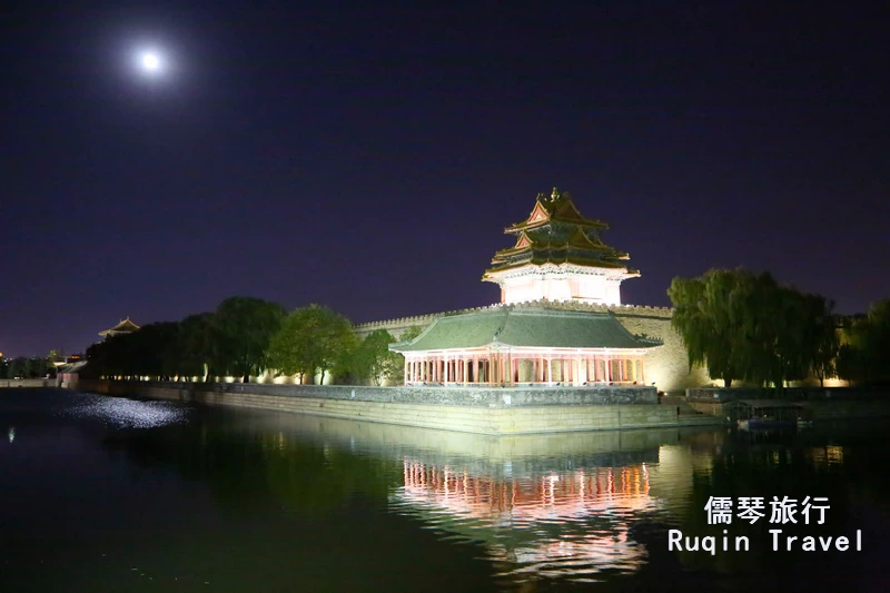 e illuminated Northwest Turret of Forbidden City under the full moon