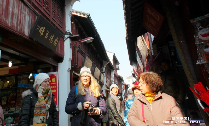 narrow lanes filled with shops and food stalls in Qibao Shanghai