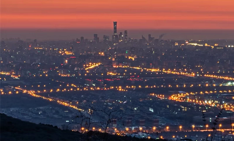 Sunrise glow over Beijing city viewed from the Ghost Laughing Stone