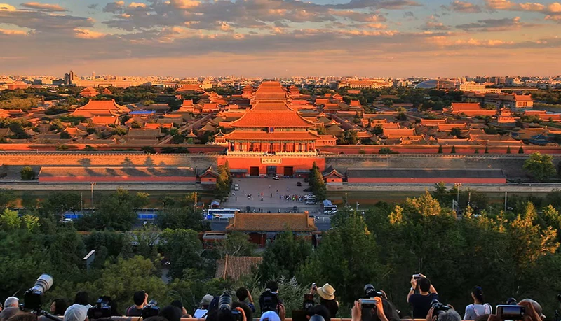 The Forbidden City under the sunrise glow seen from the top of Jingshan Park