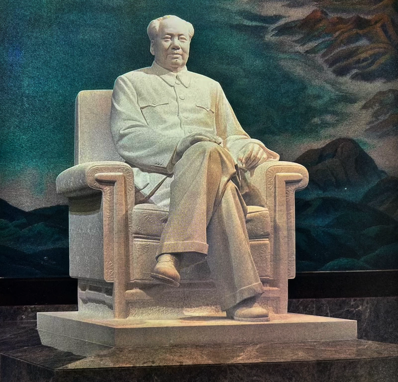 a white marble statue of Chairman Mao sits in the center