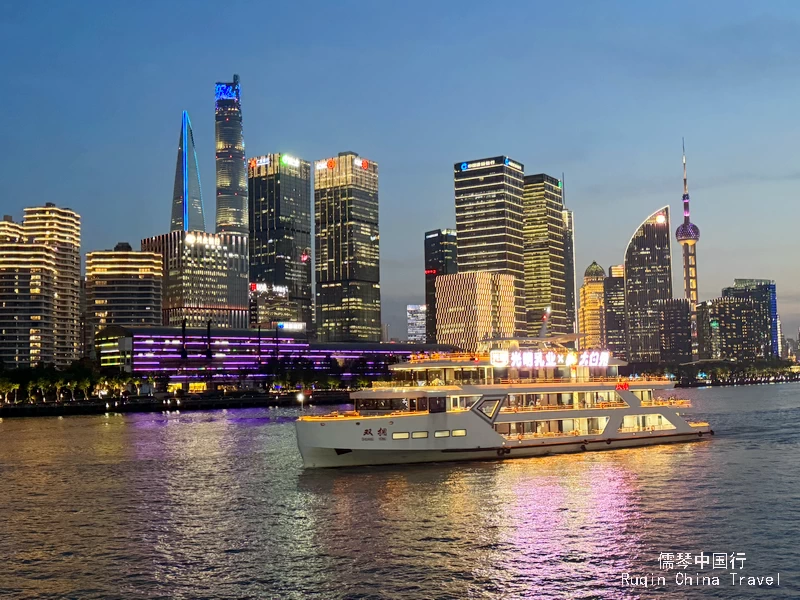 Enjoy the beautifully illuminated cityscape on the Huangpu River Cruise