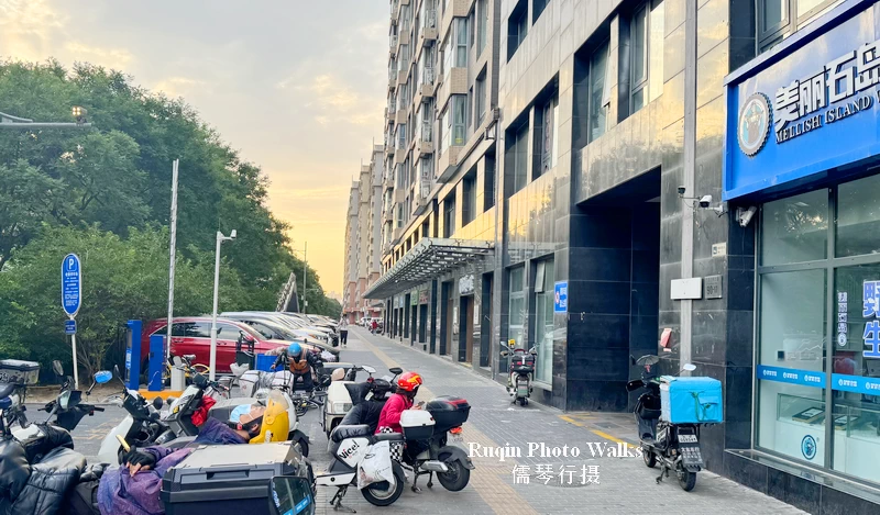 The sidewalk was quiet, with few pedestrians and most storefronts still closed at Guangqumen Inner Street