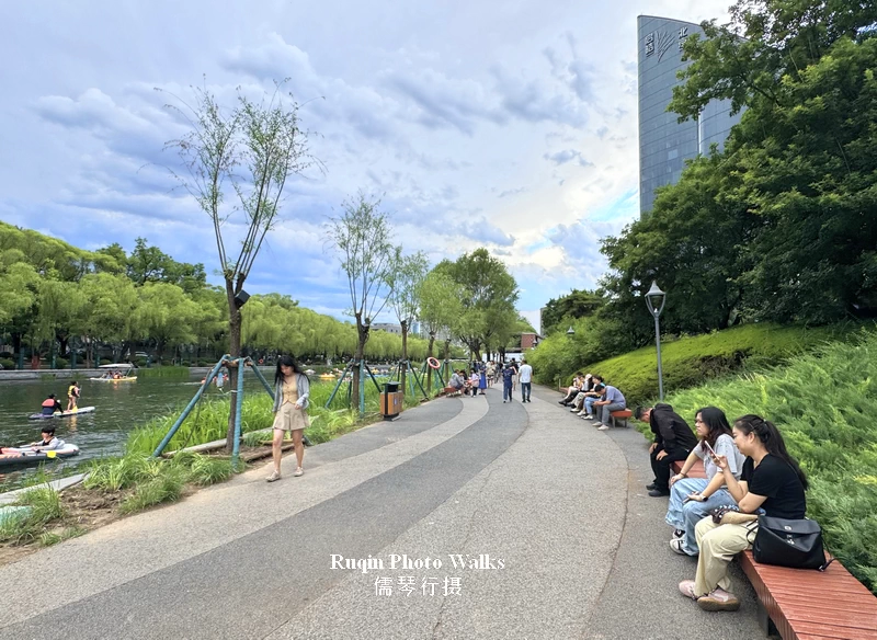 The walkway here is wide, and people walk in small groups or alone, each in their own pace along LIangma Riverside