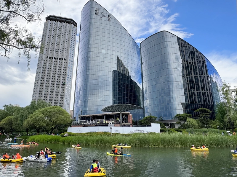 Large hotels and office towers quietly line the riverbank of Liangma River