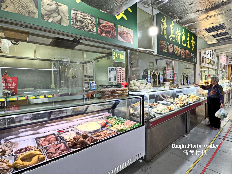 Halal food stalls selling cooked beef, lamb, and freshly baked breads at Longtan Morning Market
