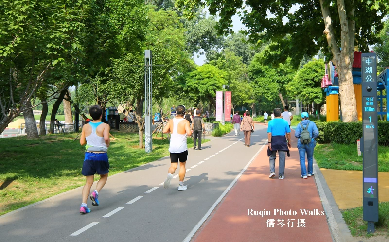 people jogging, walking, or exercising before work at Longtan Mid Lake