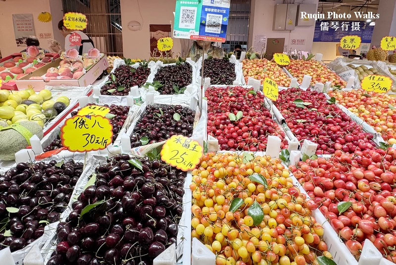 trays of tart cherries sat beside colorful local cherries ar Longtan Market in Beijing