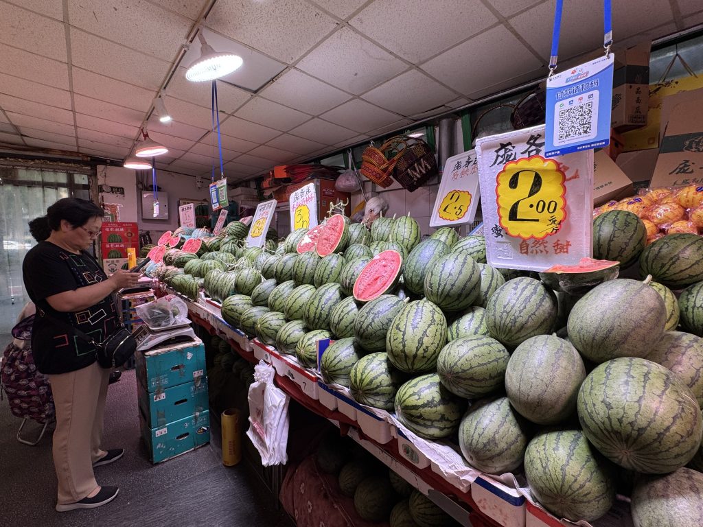 Watermelons were stacked in tall pyramids at several stalls at Longtan Market in Beijing