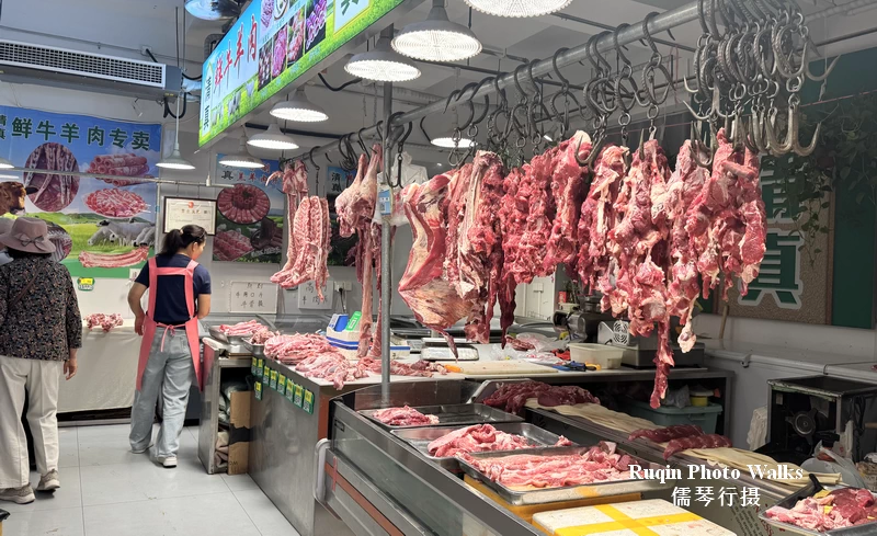 There were halal lamb stalls with neatly cut pieces hanging in display cases at Longtan Market Beijing