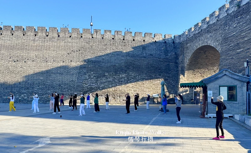 A small dance group following an instructor at the entrance to the Southeast Corner Tower at Beijing Ming Dynasty Wall Relics Park
