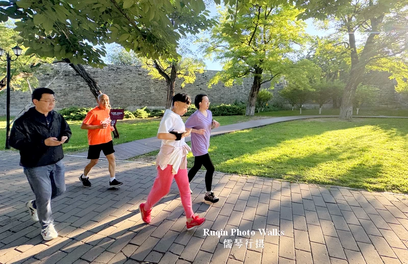 Some people are jogging along the path beside the Wall in Ming Dynasty Wall Relics Park.