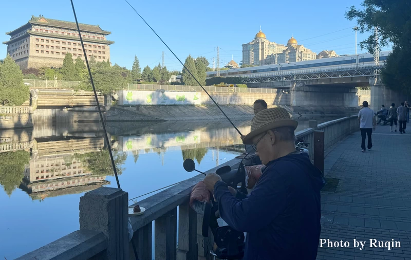 The Southeast Corner Tower, a Morning Train Passing, and Seniors Fishing and Walking Along the Moat in Beijing